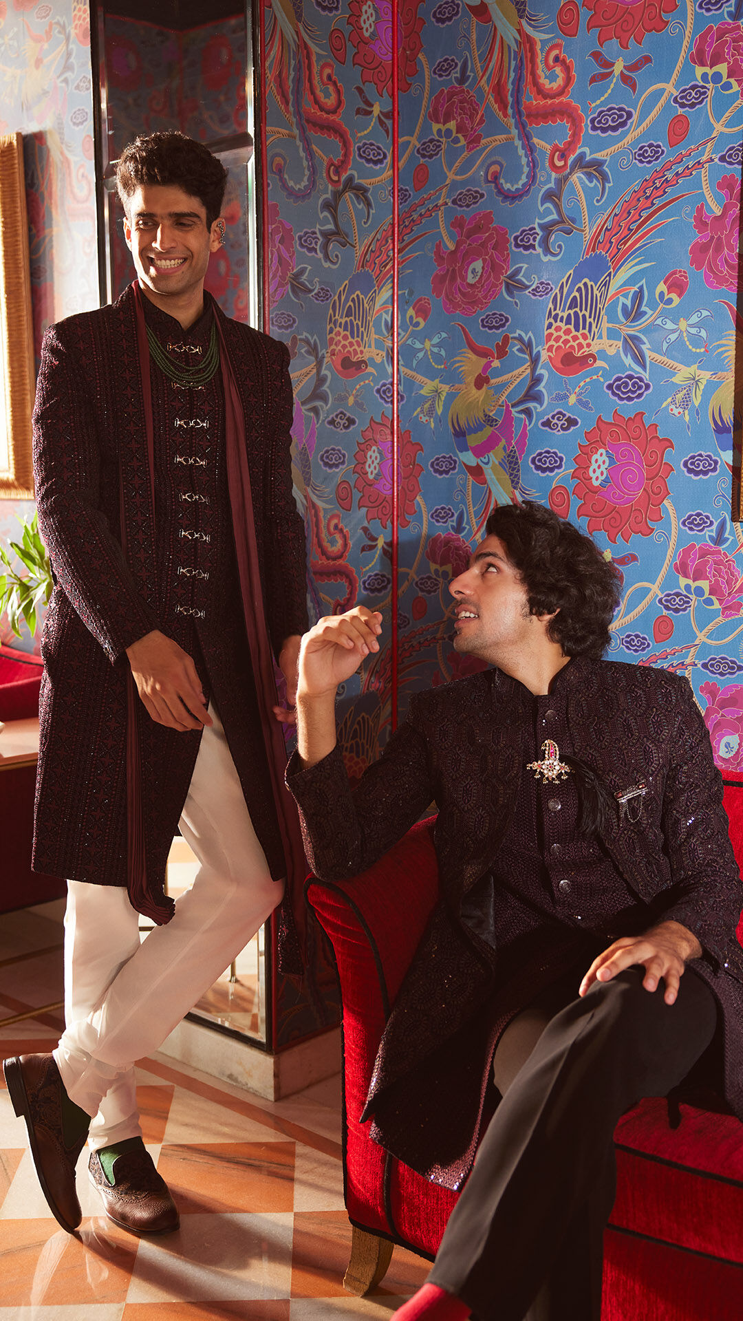 Two friends posing together in traditional attire during a festive photoshoot